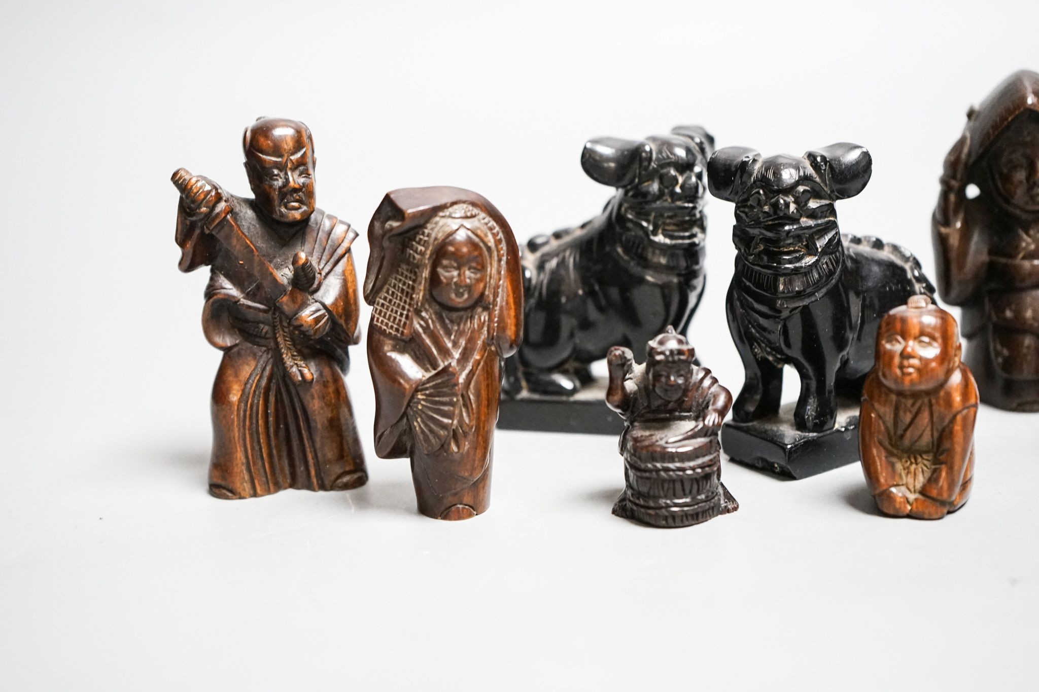 A quantity of hardwood netsuke and other carvings, signed